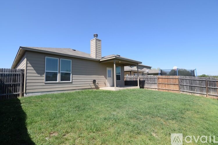 A house with a fence and a backyard.