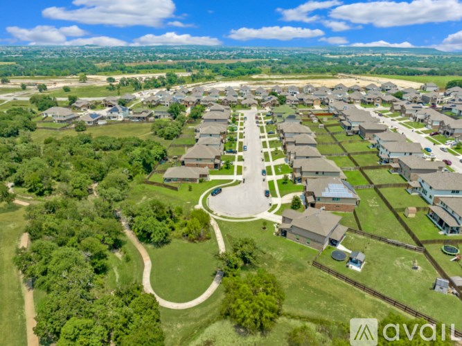 A bird's eye view of a residential area with houses and greenery.