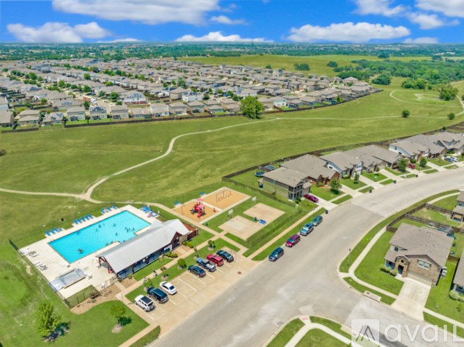 A bird's eye view of a residential area with a swimming pool and a playground.