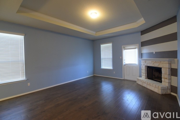 A room with a fireplace and striped wallpaper.