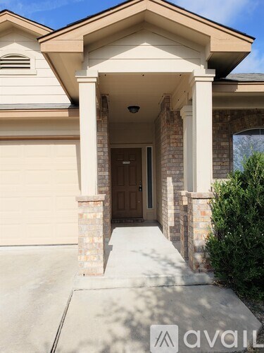 A house with a brown door and a covered porch.