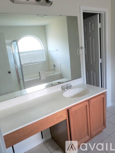 A bathroom with a sink and mirror.