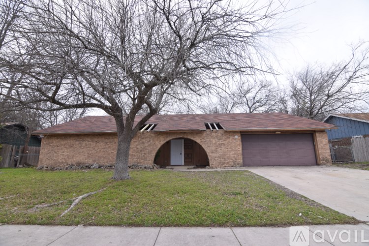A house with a tree in front of it.