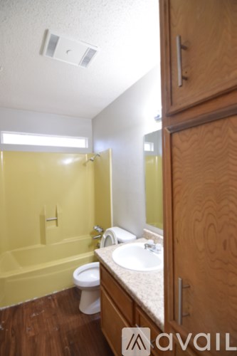 A bathroom with a toilet, sink and shower.