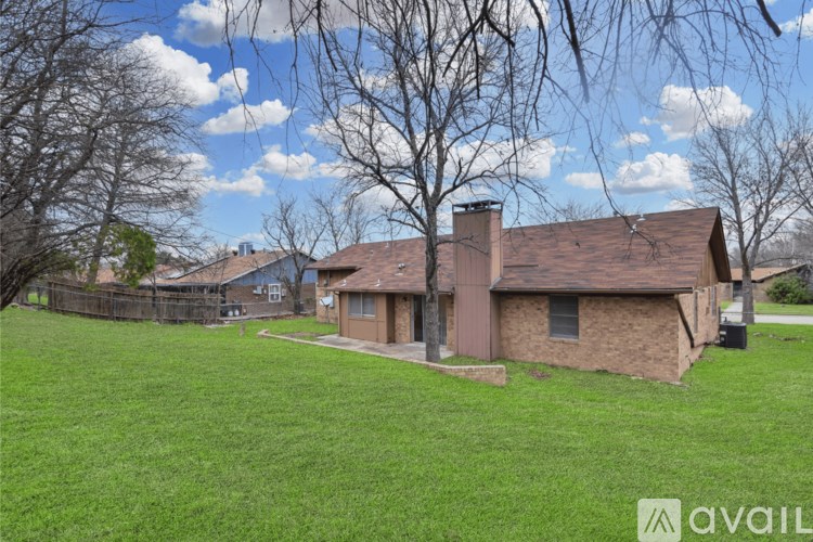 A house with a brown roof and a brown fence.