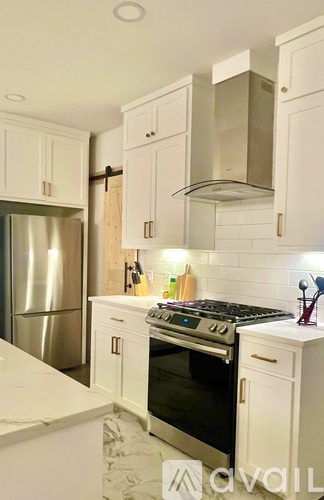 A modern kitchen with white cabinets and a large island.