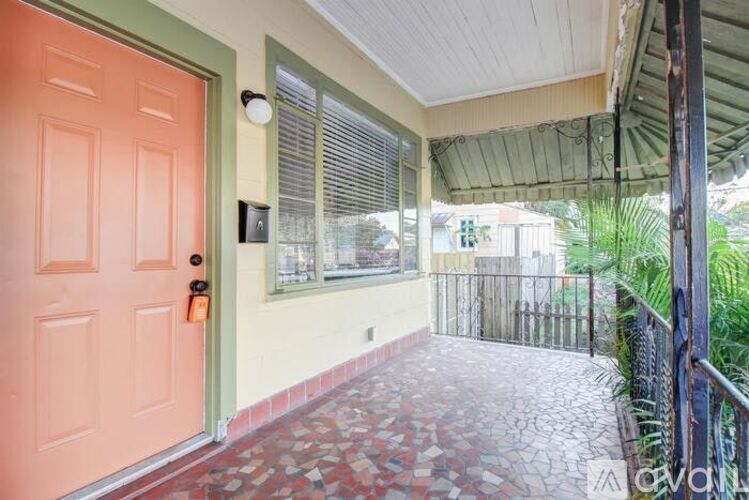 A red door is on the left of a yellow wall.