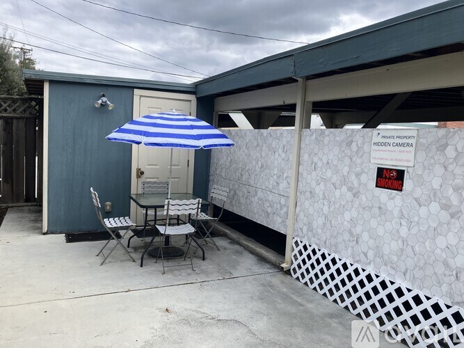 A bedroom with a bed, nightstands, and a painting on the wall.