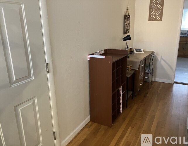 A living room with a black couch and a coffee table.