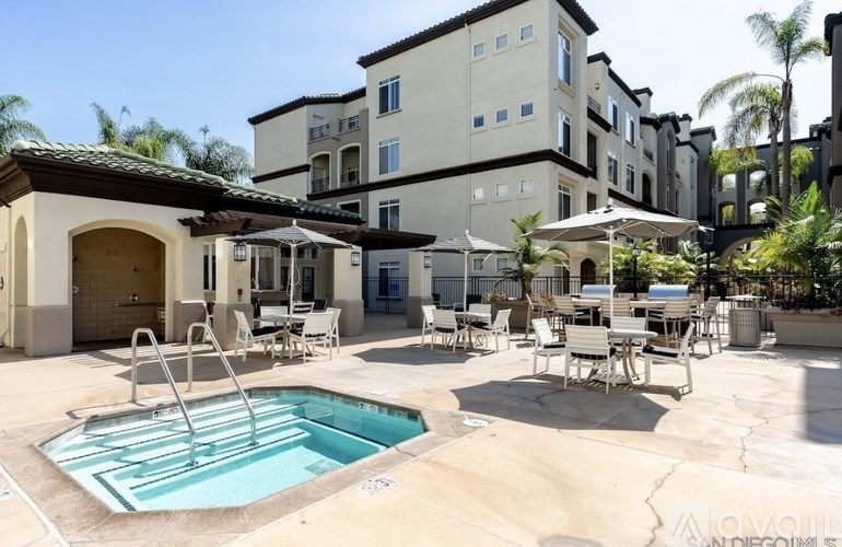 A pool area with a small pool and sun loungers.