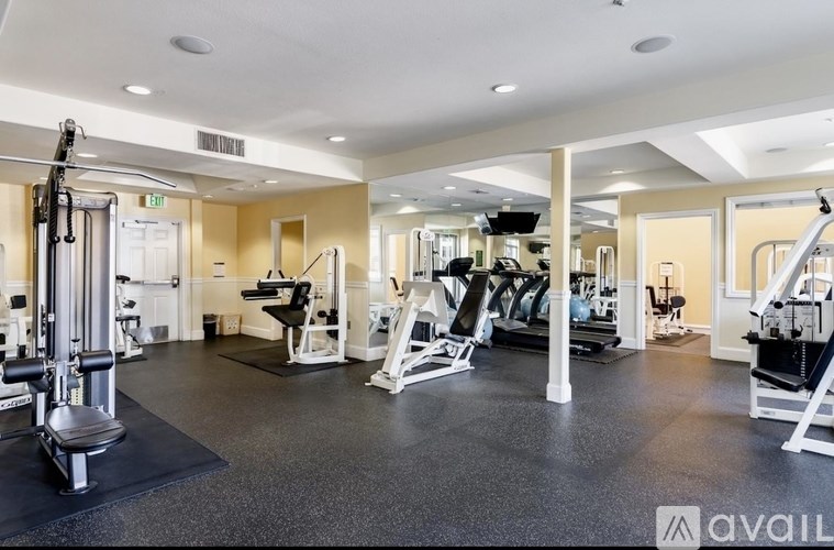 A spacious home gym with a variety of equipment.