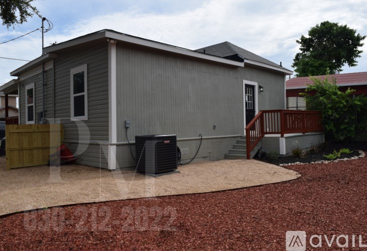 A house with a grey siding and a brown roof.