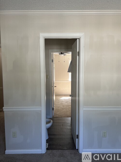 A white doorway leads to a hallway.