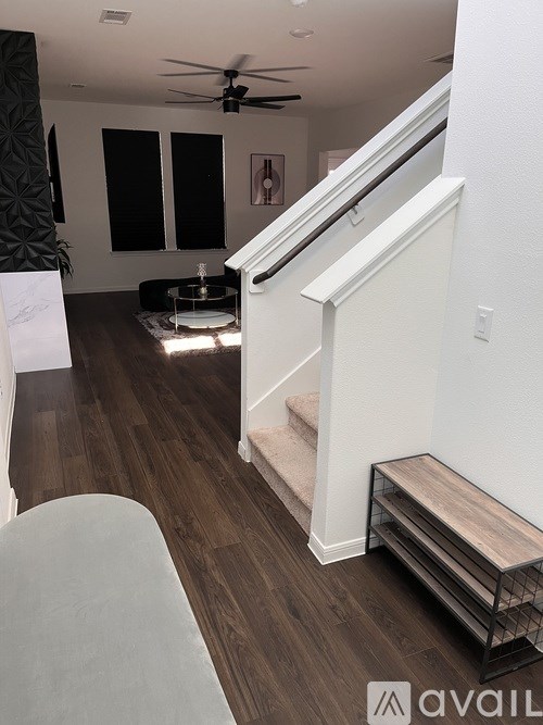 A living room with a staircase leading to the upper floor.