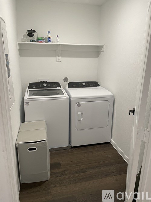 A small laundry room with a washer and dryer.