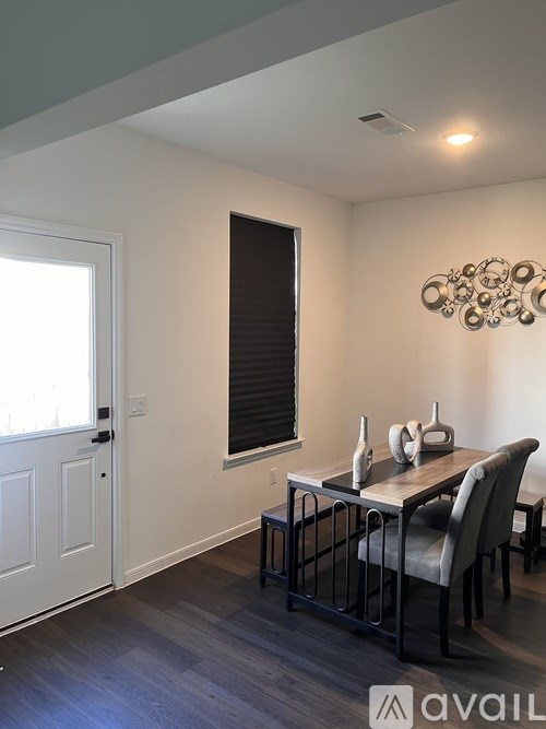 A dining room with a table set for two.