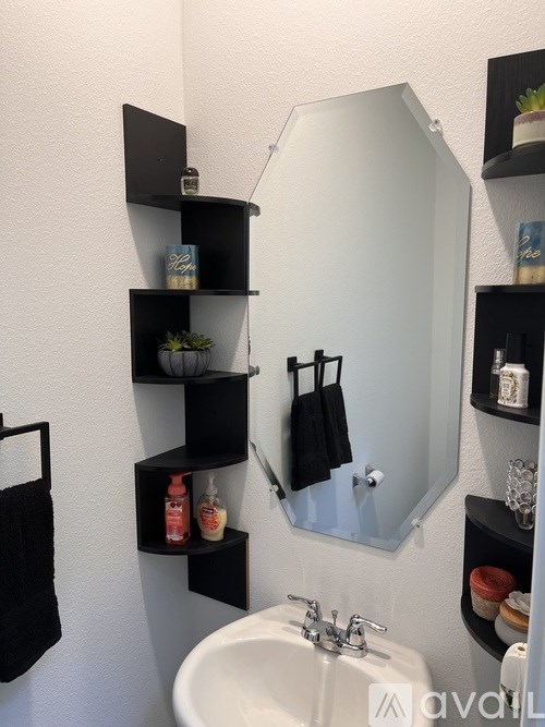 A bathroom with a white sink and a mirror above it.