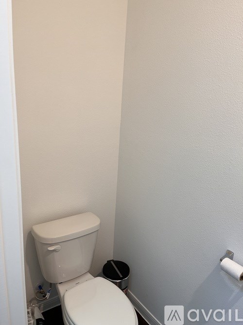 A white toilet in a small bathroom.