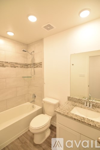 A room with a ceiling fan and a window with blinds.