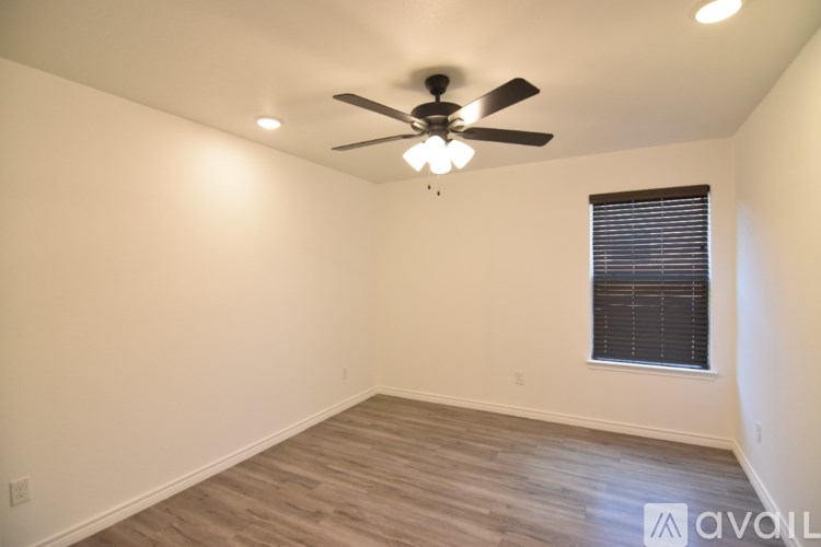A backyard with a wooden fence and a clear sky.
