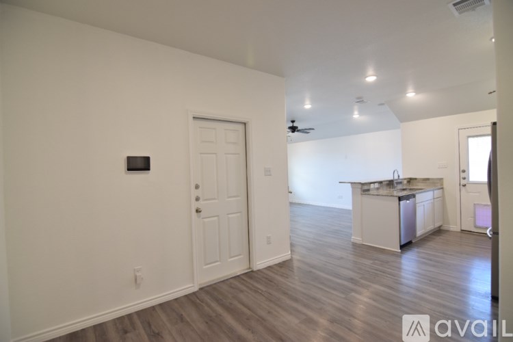 A kitchen with a granite countertop and stainless steel appliances.