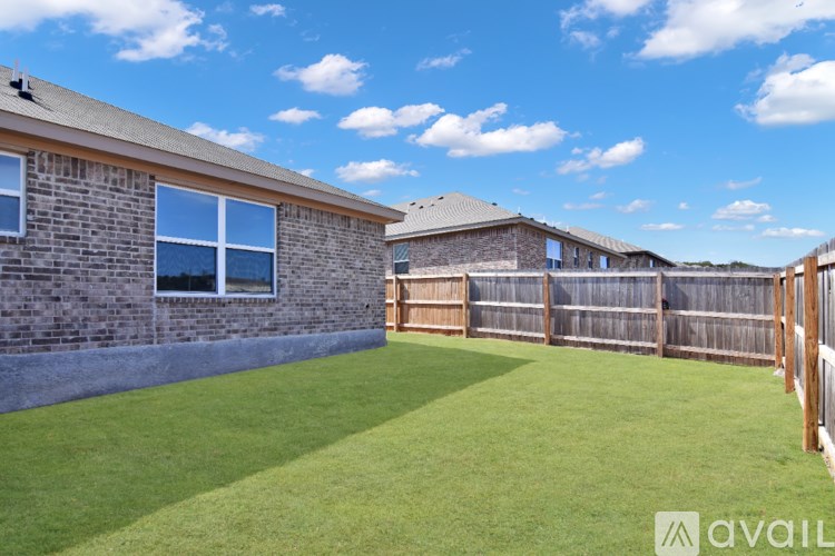 A spacious room with a ceiling fan and wooden flooring.