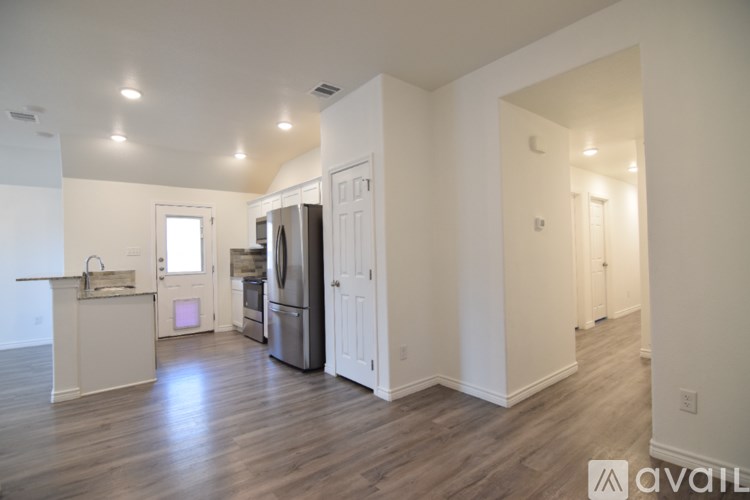 A room with a ceiling fan and a window with blinds.