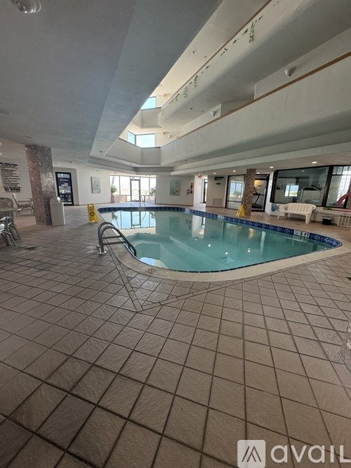 A large indoor swimming pool with a tiled floor.
