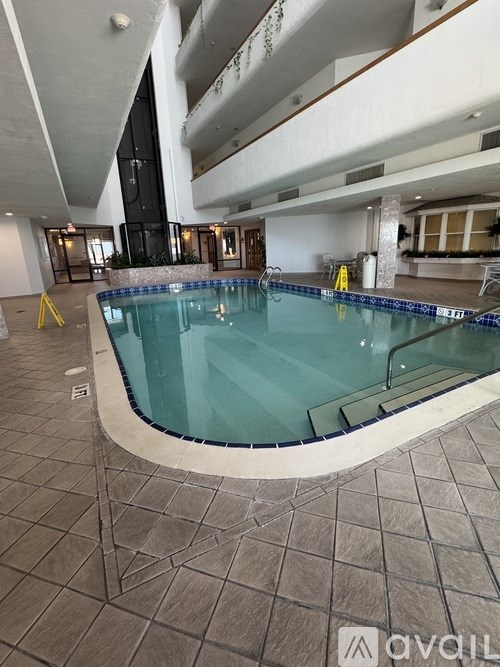 A large indoor swimming pool with a tiled floor.