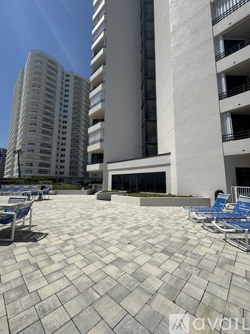 A sunny day at the outdoor seating area of a modern building.