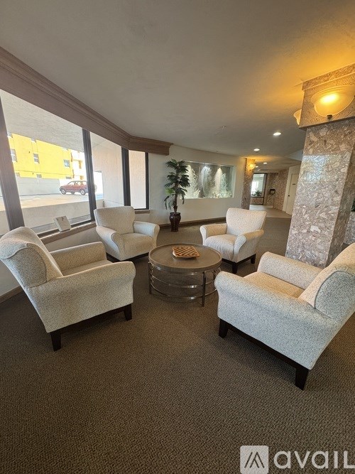A living room with a stone pillar and a carpeted floor.