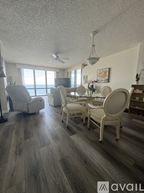A living room with a striped couch and a flat screen TV.