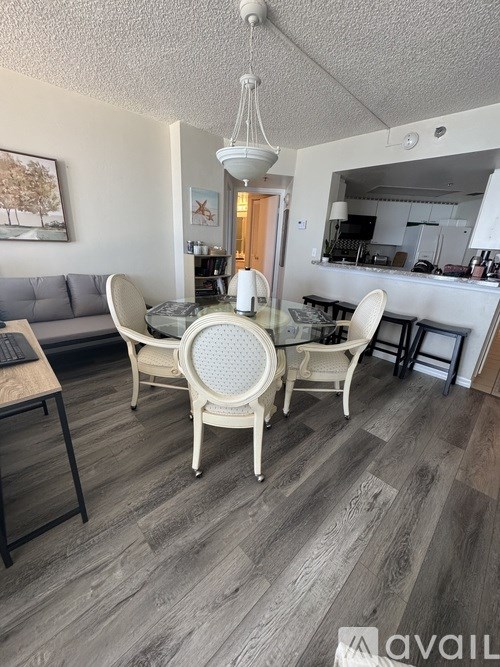 A dining room with a table and chairs.