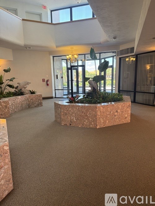 A large indoor space with a stone planter in the middle.
