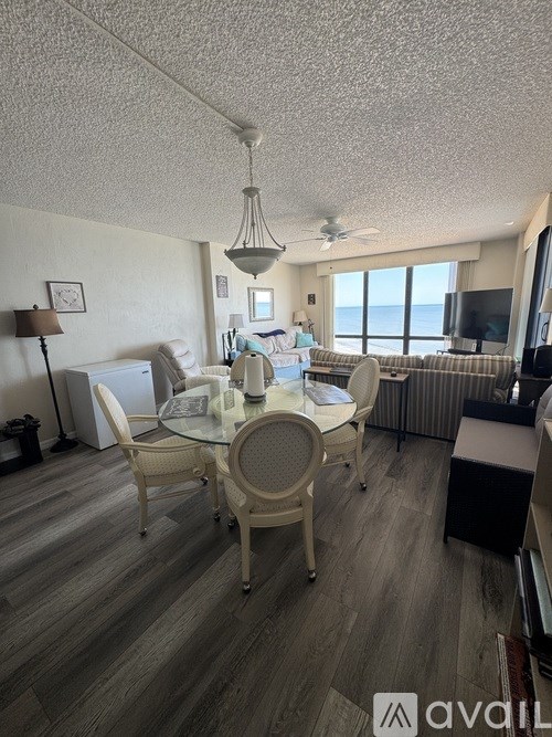 A living room with a dining table and chairs.