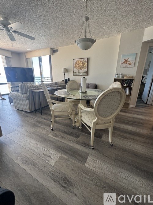 A dining room with a glass table and chairs.