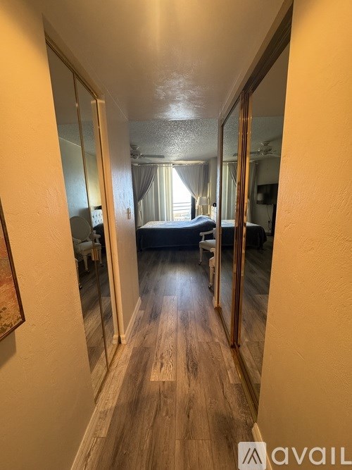 A hallway with a bedroom at the end.