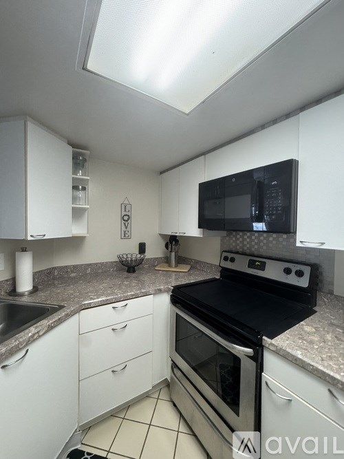 A kitchen with white appliances and white cabinets.