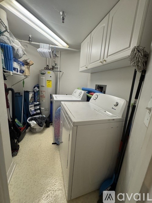 A small laundry room with a washer and dryer.