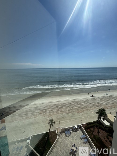 A sunny day at the beach with people enjoying the sun and the sea.