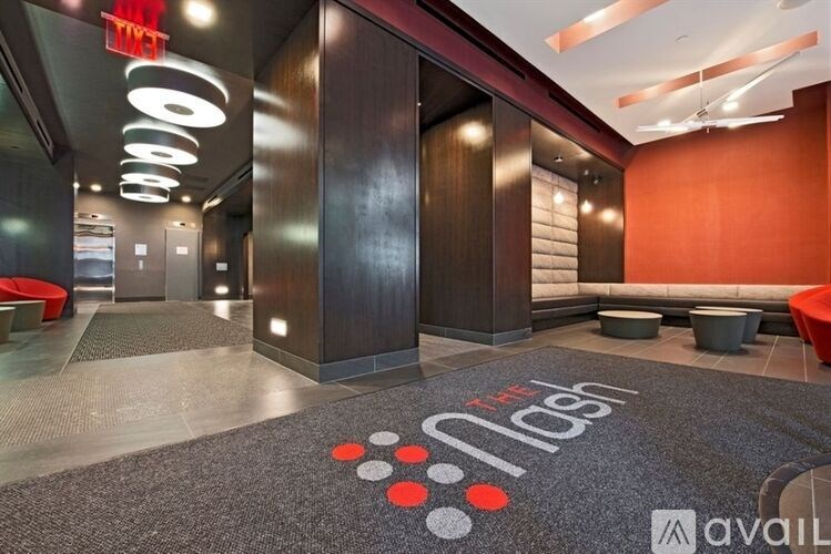 A room with a carpet that has the text "The Avail" on it.