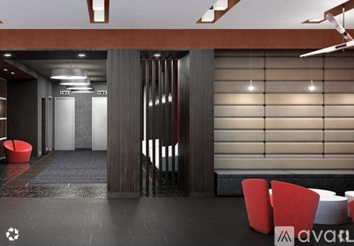 A modern office lobby with a red chair and a logo that reads "avail".