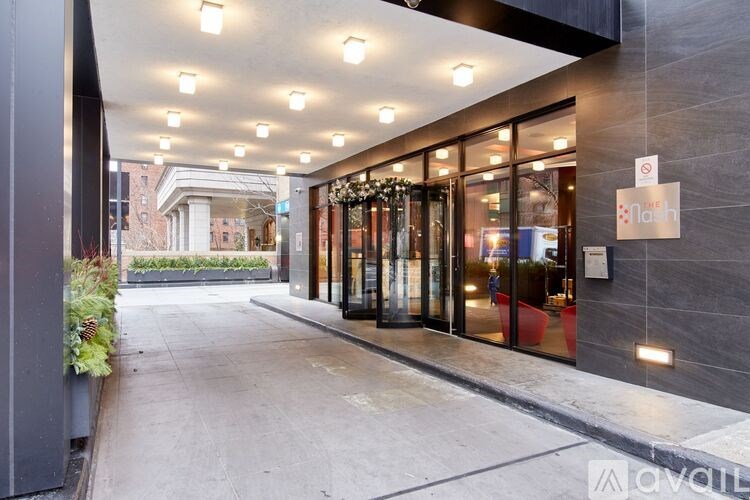 The image shows a modern building entrance with glass doors and a sign that reads "Larkin".