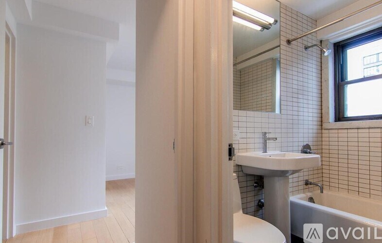A bathroom with a sink, toilet, and bathtub.