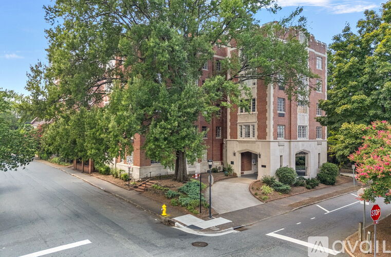 A street view of a residential area with a building on the corner.