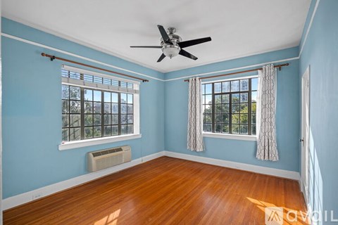 A room with blue walls and a ceiling fan.
