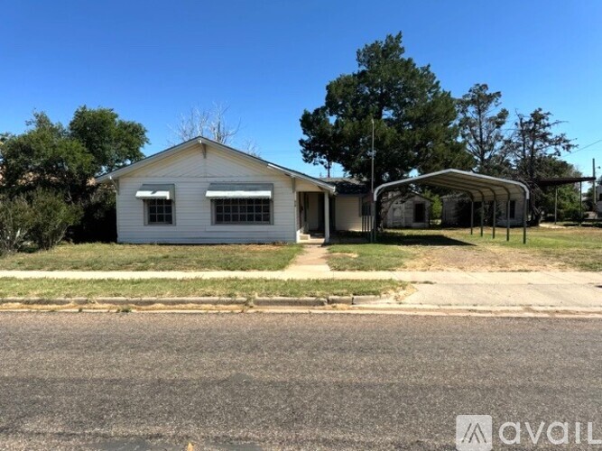 A house with a white exterior and a covered patio area is available for rent.