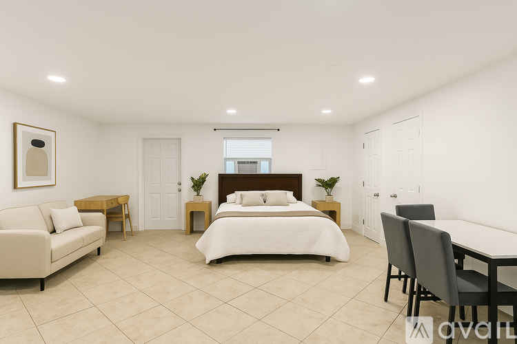 A bedroom with a bed, couch, and table.