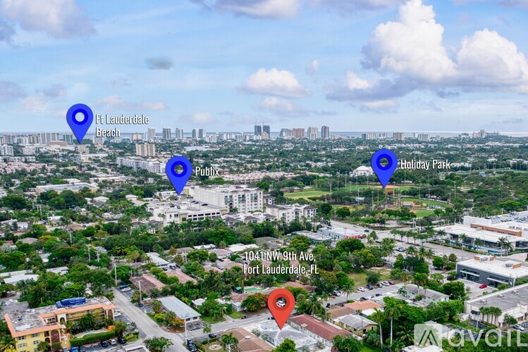 An aerial view of a city with marked locations including a beach, a public park, and a specific address.