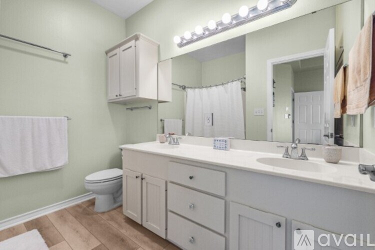 A bathroom with a white toilet and a white sink.